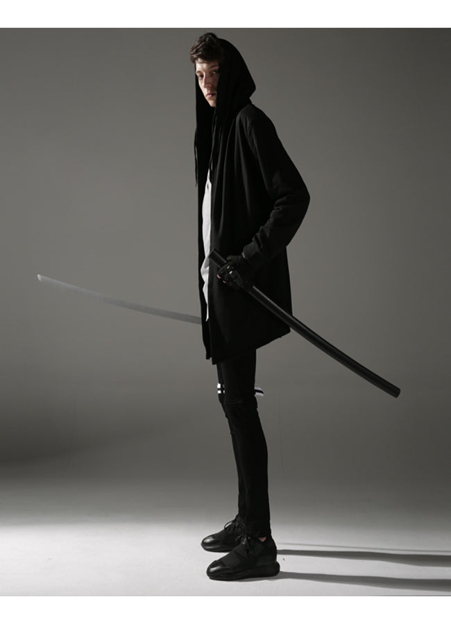 male model wearing a cyberpunk overcoat from profile